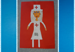 Wycinanka z kolorowego papieru przedstawiająca postać pielęgniarki. Osoba jest ubrana w biały strój i ma na ubraniu czerwony krzyż. Całość przyklejona jest do czerwonego kartonu. Praca została wyróżniona.
